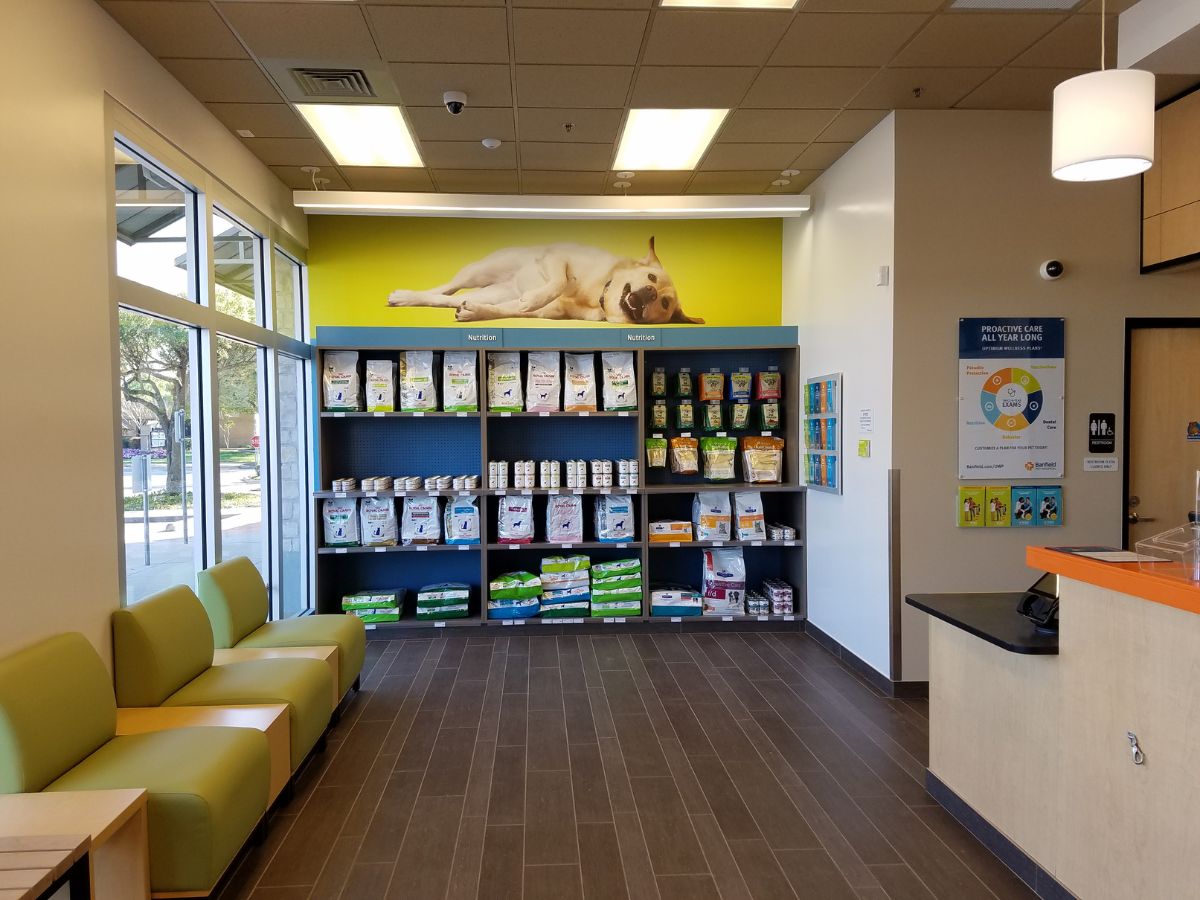 The Banfield - Fort Worth Trinity Commons supply shelves and front desk